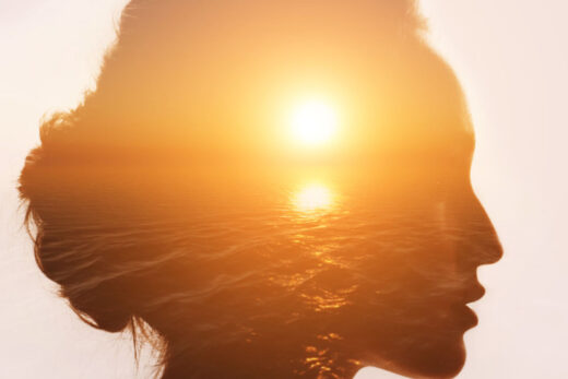 transparent profile of a woman with a sunset over the sea in the background, symbolizing the Philosophy of Mind