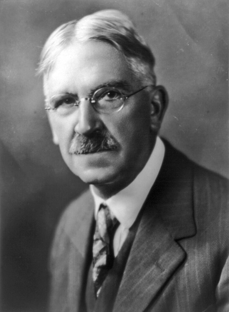 Portrait of John Dewey, a key figure in pragmatism and instrumentalism, respected among professional philosophers for his contributions and critical role in advancing the philosophy